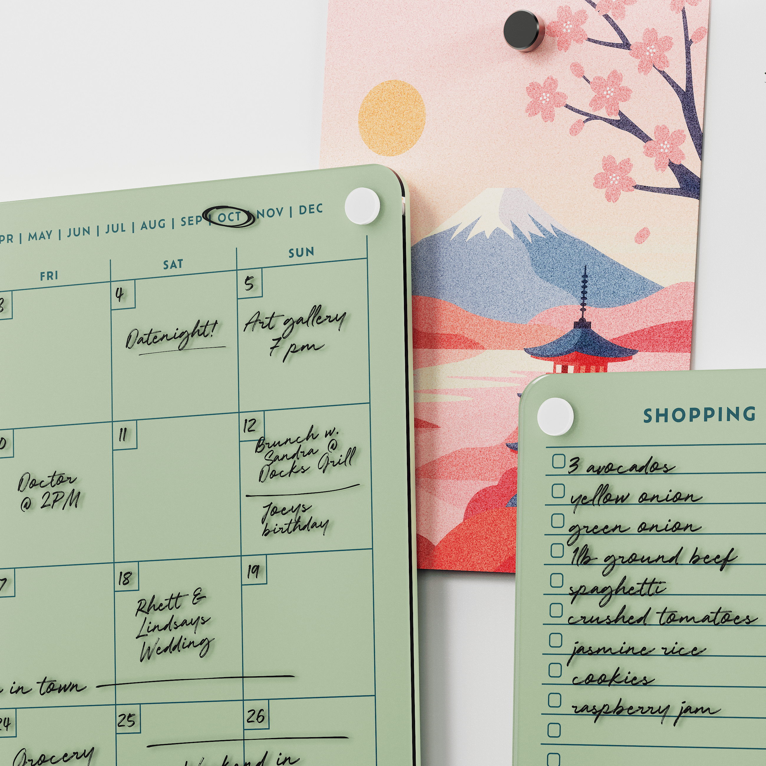 Close-up of the Matcha green monthly calendar and shopping list boards with handwritten plans and groceries